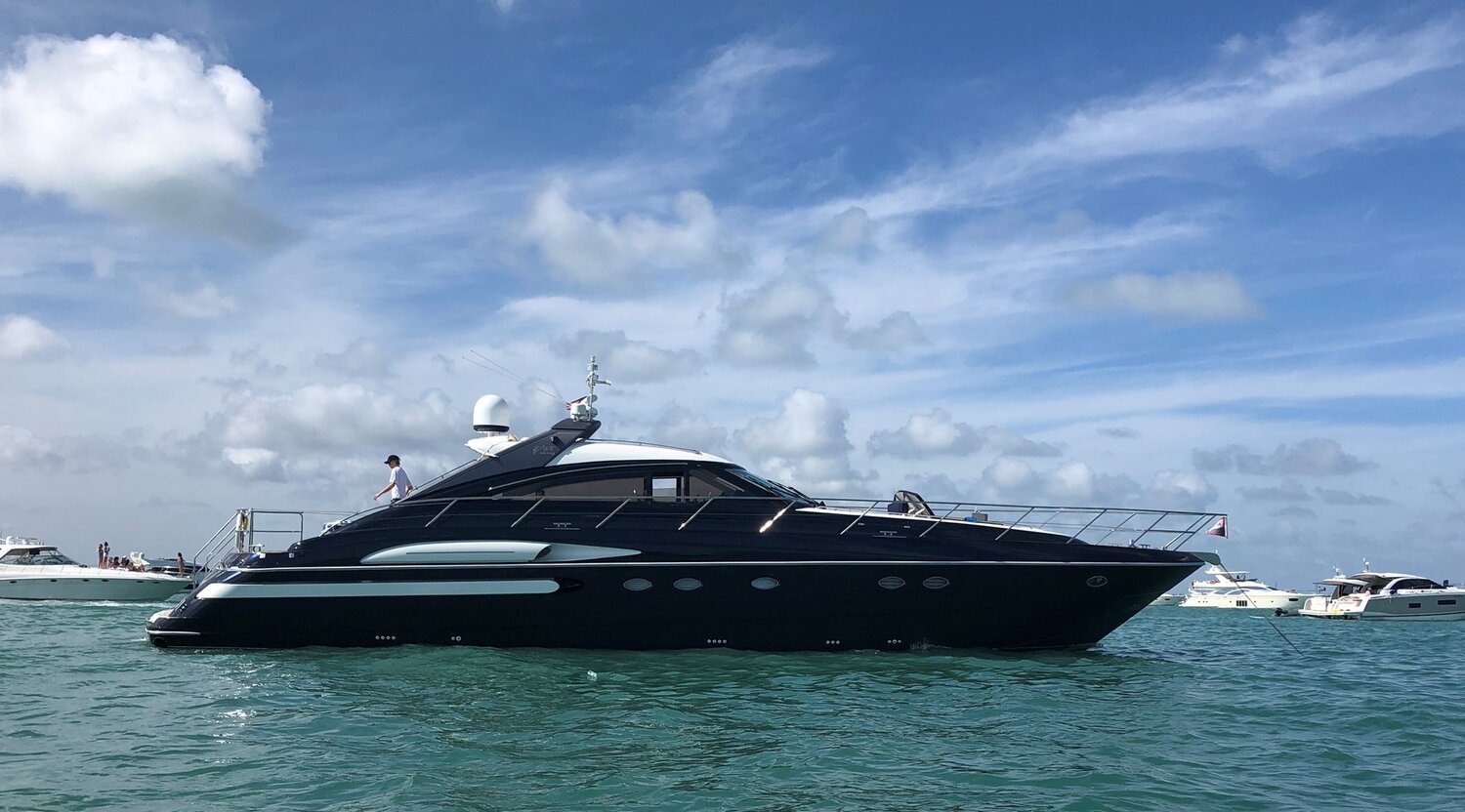 Black yacht on the water with a clear blue sky with fresh wrap